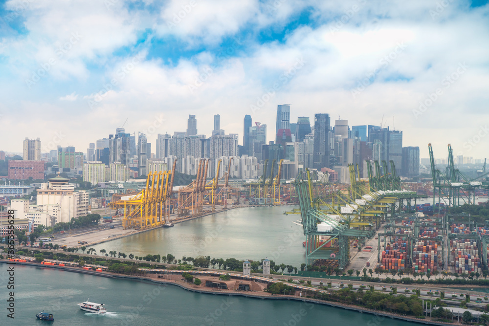 Fototapeta premium Singapore cargo terminal,one of the busiest Import, Export, Logistics ports in the world with skyline and office building skyscraper business downtown district in Singapore..