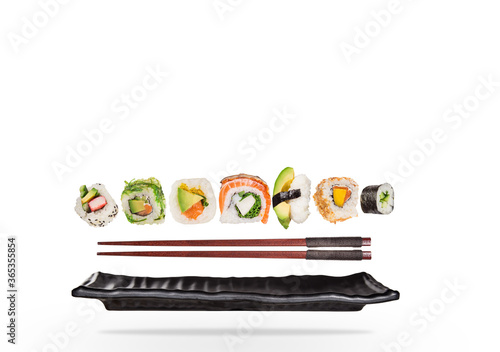 Pieces of delicious japanese sushi frozen in the air. Isolated on white background