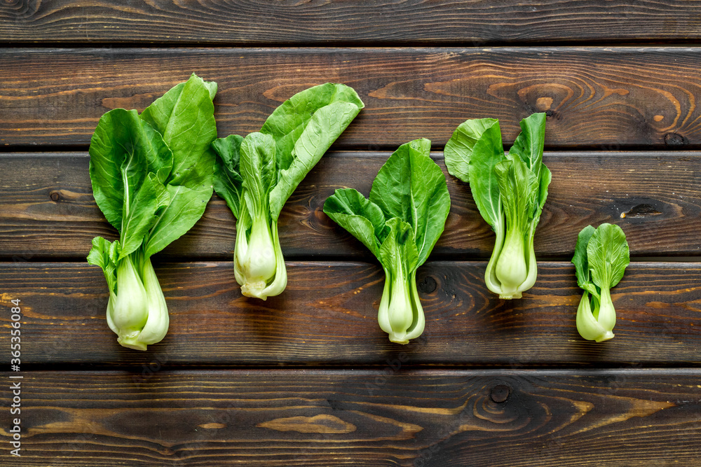 Bok choy pattern on wooden background top-down