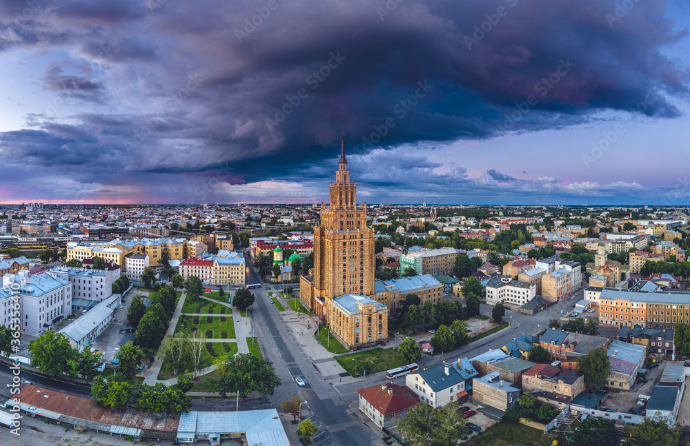 Aerial view of iconic Riga city in dramatic sunset. Modern architecture in Europe with storm clouds