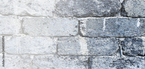 Old rustic gray brick wall panorama. Masonry gray texture or background. Copy space for text or description.
