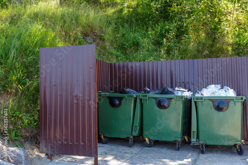 Garbage bins are fenced with metal shields