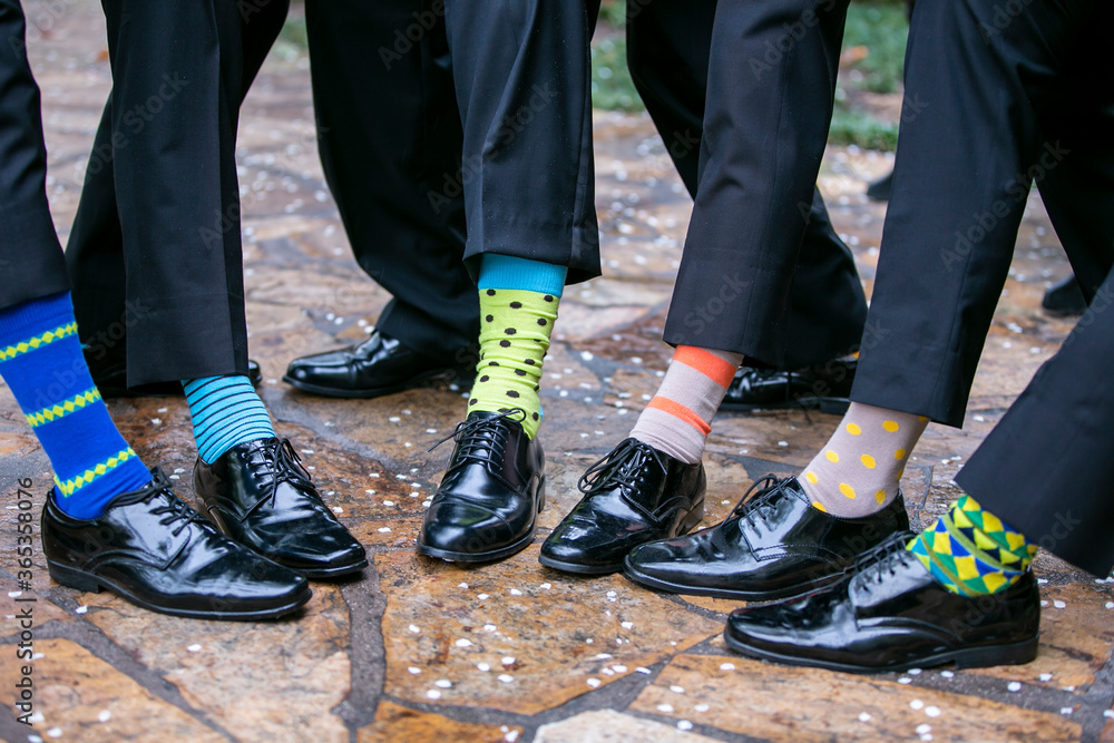 Group of wedding groomsmen showing their socks at a marriage reception Group of wedding groomsmen showing their socks at a marriage reception