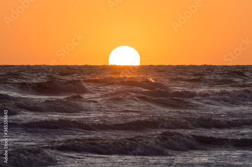 Fototapeta Naklejka Na Ścianę i Meble -  Sunset with rough sea on the beach