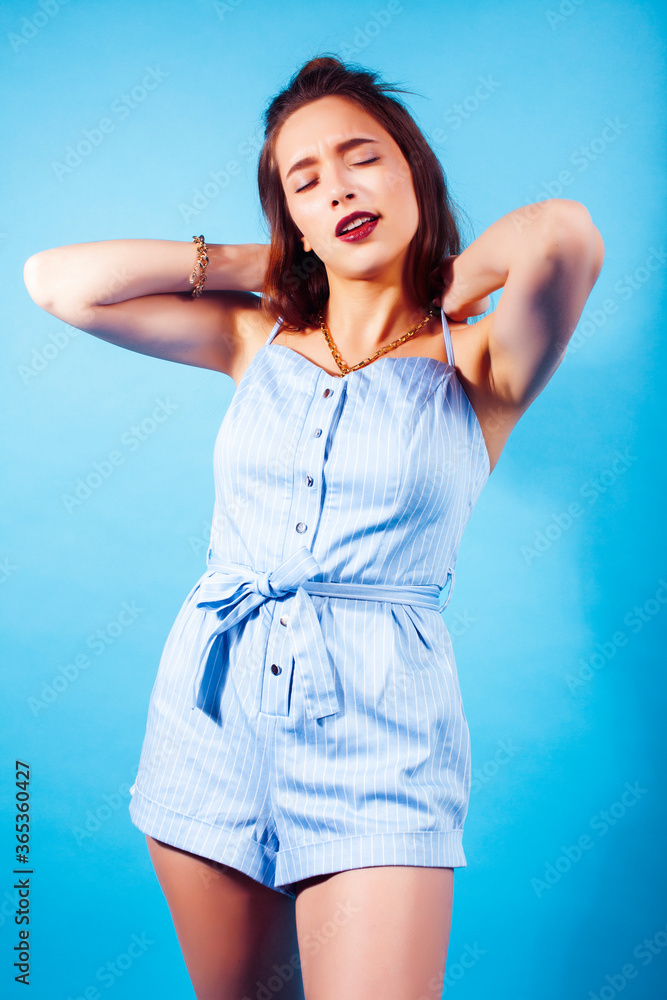 young pretty girl posing happy smiling on blue background, lifestyle people on summer vacation concept young pretty girl posing happy smiling on blue background, lifestyle people on summer vacation concept