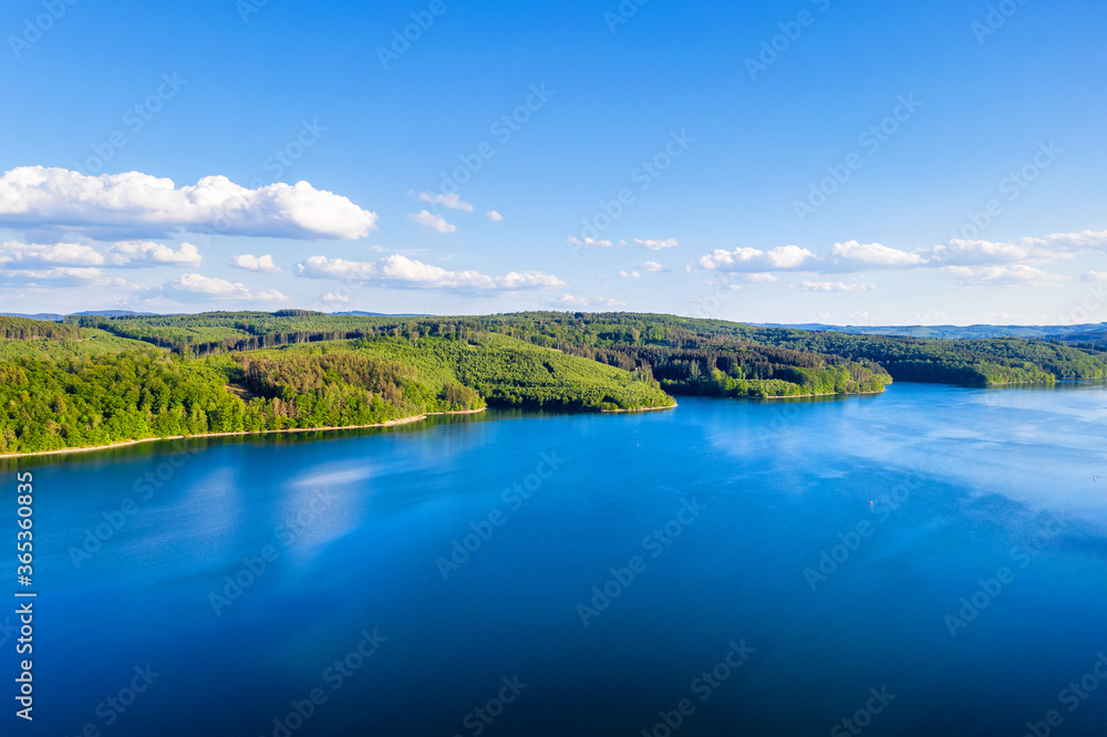 a beautiful lake with a forst shore from above