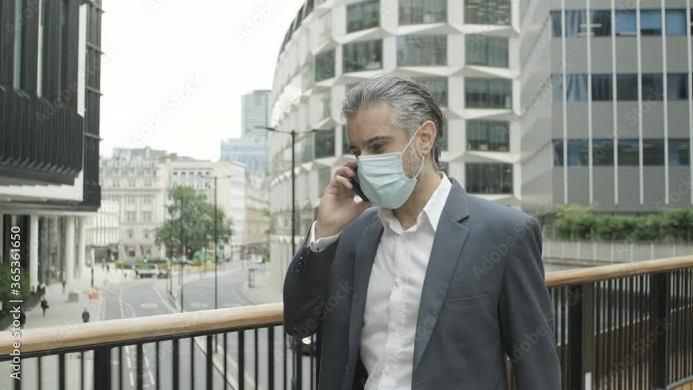 Corporate business man commuting to work wearing face mask in the city of London during Covid-19 Pandemic Corporate business man commuting to work wearing face mask in the city of London during Covid-19 Pandemic