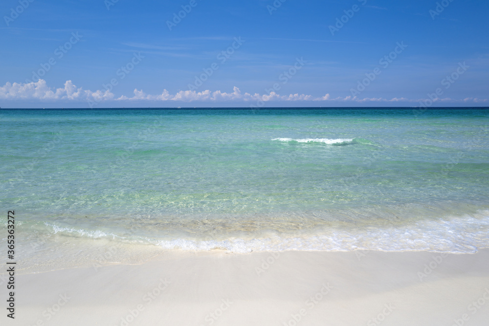 Clouds with blue sky over calm sea beach in tropical Maldives island.