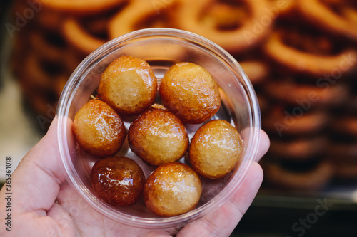 Traditional Turkish  Lokma dessert fryied in oil and sweetened with syrup photo