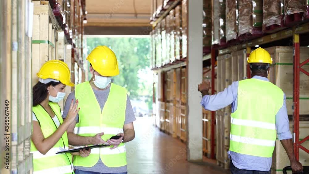 Diversity workers wear face mask as new normal greeting in warehouse Diversity workers wear face mask as new normal greeting in warehouse
