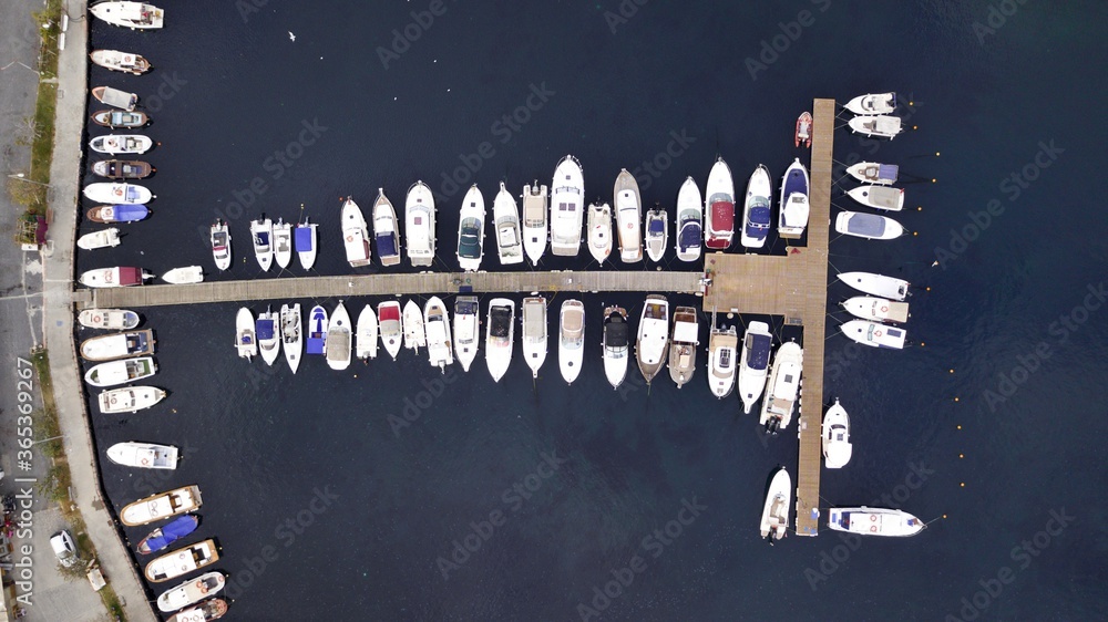 Aerial view of boats are parking at the pier by beautiful blue sea, drone shot. Aerial view of boats are parking at the pier by beautiful blue sea, drone shot.
