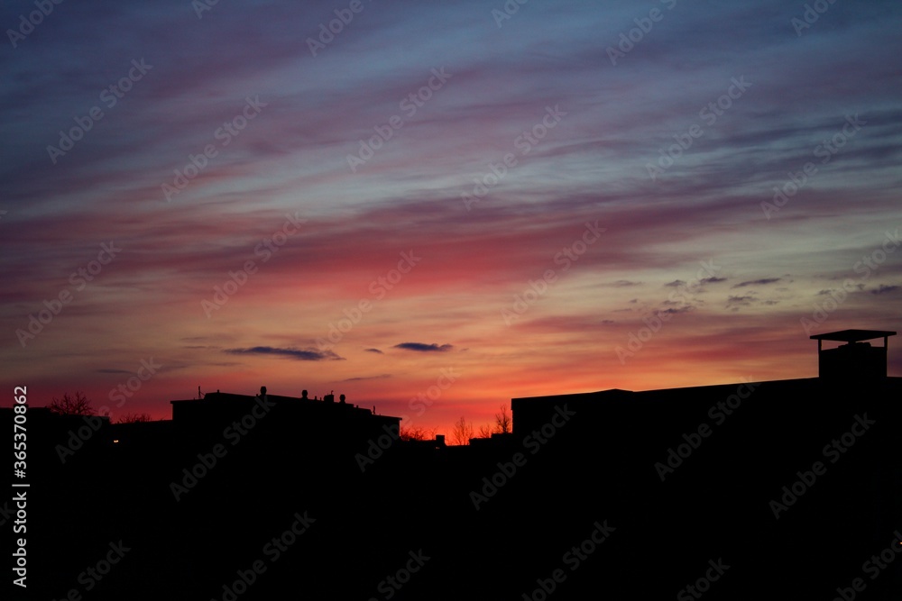 Silhouette of buildings with pinkish red twilight sky in the background captured in Kiruna, Sweden