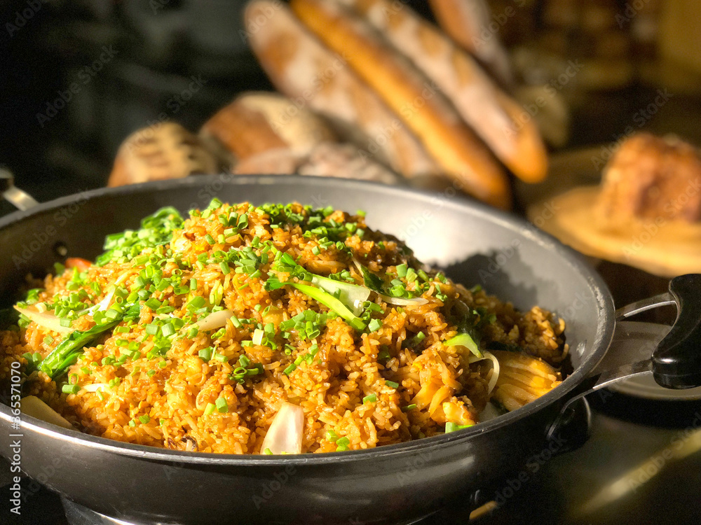 Garlic fried rice with vegetables on top and bread background Garlic fried rice with vegetables on top and bread background