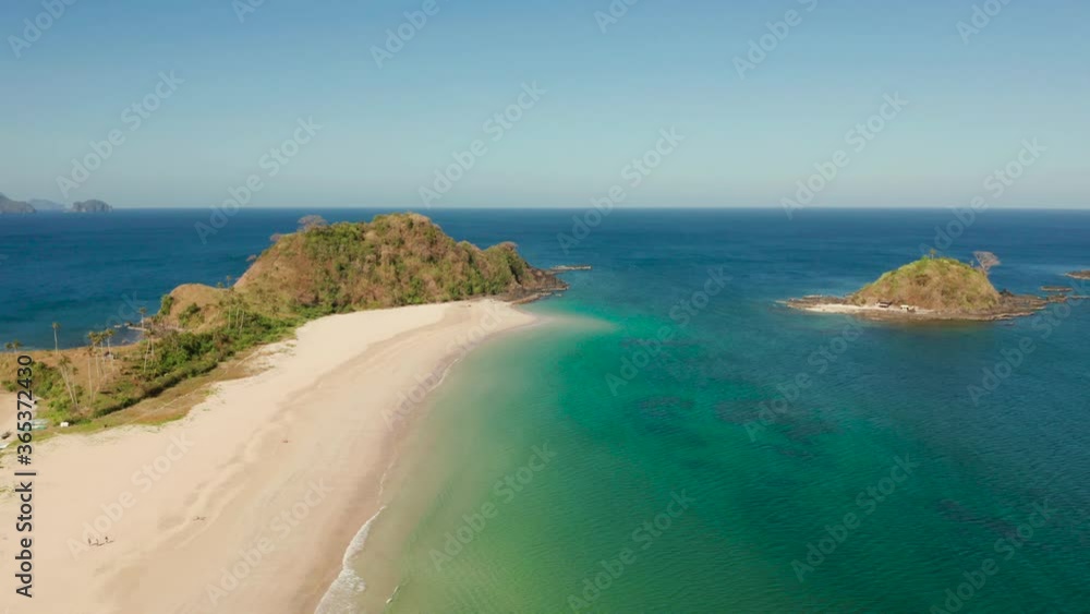 Aerial drone blue sea and tropical beach. Nacpan, El Nido, Palawan, Philippine Islands. Seascape with tropical beach and islands. Summer and travel vacation concept Aerial drone blue sea and tropical beach. Nacpan, El Nido, Palawan, Philippine Islands. Seascape with tropical beach and islands. Summer and travel vacation concept