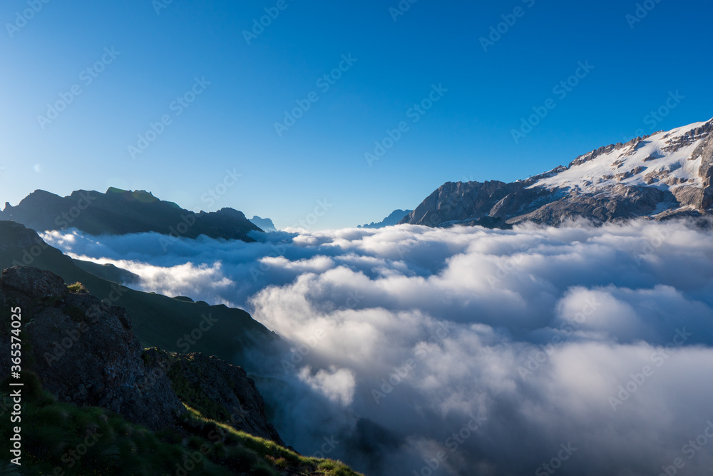 Great view of the foggy marmolada with pass pordoi. National Park. Dolomites (Dolomiti), South Tyrol. Location Canazei, Campitello, Mazzin. Italy, Europe. Dramatic scene. Beauty world.