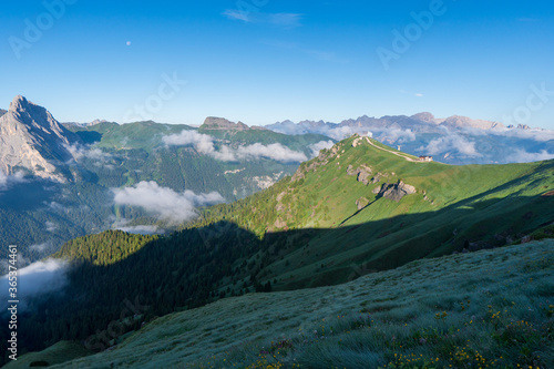Panorama of the Piz Boe mountain range at sunny foggy morning. View from Pordoi pass. Dolomites mountains, Italy, Europe.