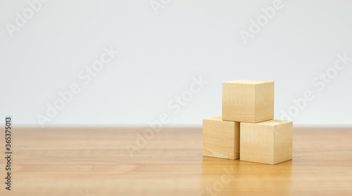 empty wooden cubes for own messages and icons on wooden floor and white background