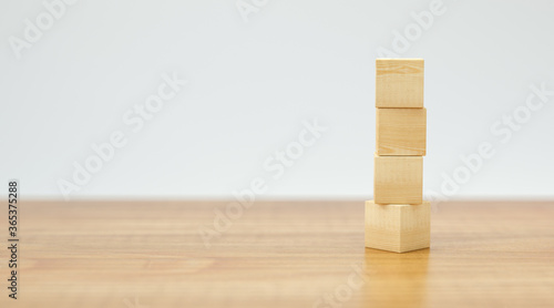 empty wooden cubes for own messages and icons on wooden floor and white background