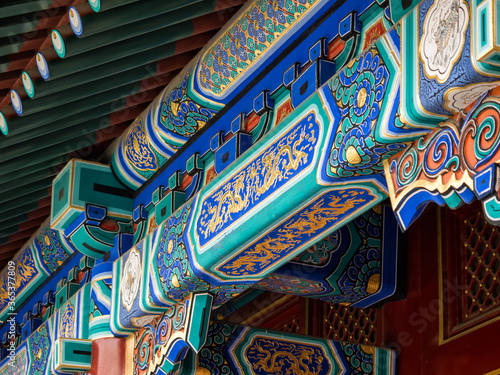 Detail of colorful traditional painting on the roof of Chinese temple