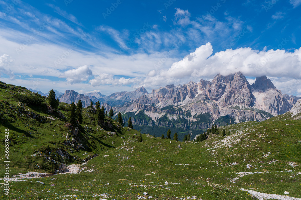 Morning panoramic view of Cima Ambrizzola, Croda da Lago and Le Tofane Gruppe, Dolomites mountains, Italy, in spring meadow