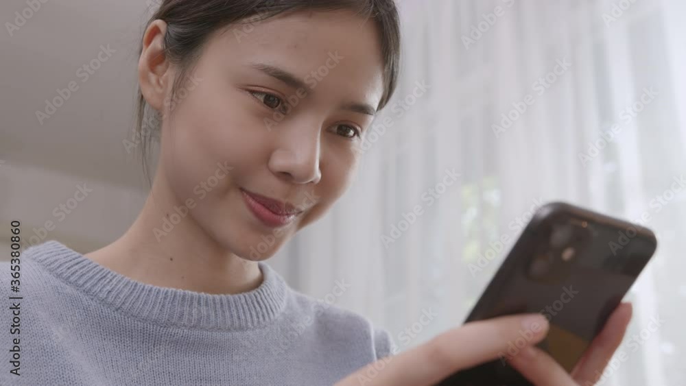 Young Asian woman holding a smartphone and using online social on lifestyle. Young Asian woman holding a smartphone and using online social on lifestyle.
