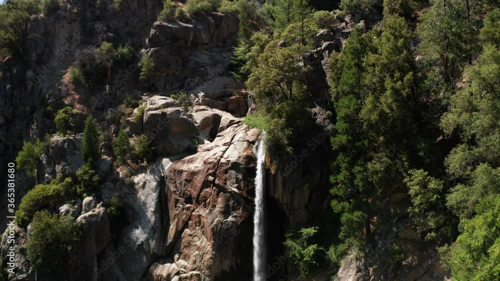 Aerial reverse pull-back shot of a beautiful 80 foot mountain waterfall. 4K Aerial reverse pull-back shot of a beautiful 80 foot mountain waterfall. 4K