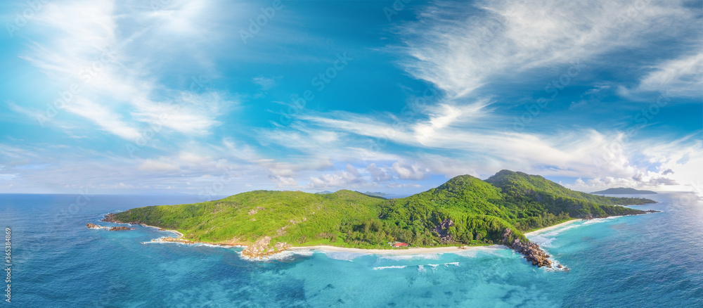 Tropical beach with sea and palm taken from drone. Seychelles famous beach - aerial photo of La Digue Grand Anse