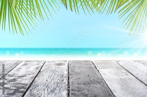 Selective focus of old wood table with beautiful beach background for display your product.