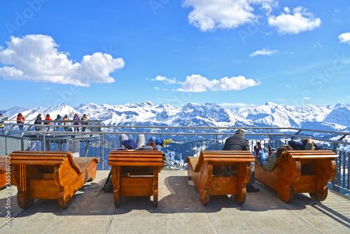 Travelers enjoy sun light at the sun terrace on Stanserhorn mountain
