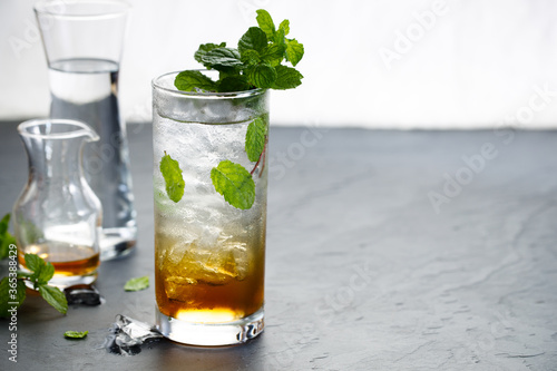 Glass of cold drink with fresh mint leaves
