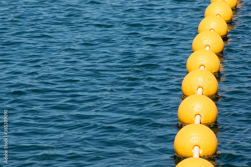 Fotografie String of Buoys Floating on Ocean Surface