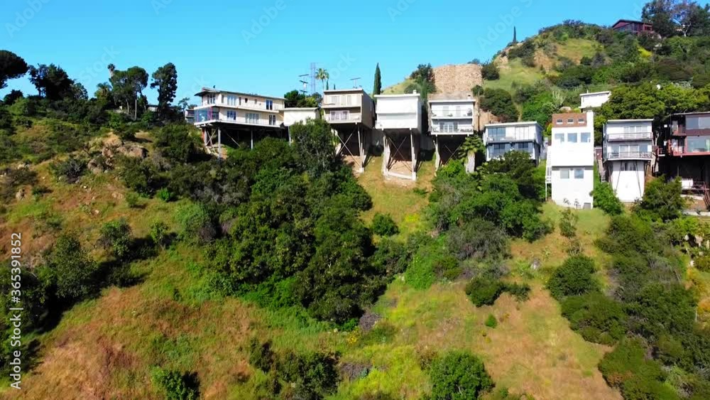 Birds-eye-view of the Hollywood Hills Homes. Rise to and above. Nice transitional shot. 16 sec. Birds-eye-view of the Hollywood Hills Homes. Rise to and above. Nice transitional shot. 16 sec.