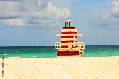 Atlantic Ocean background. Miami South Beach lifeguard tower and coastline with cloud and blue sky.