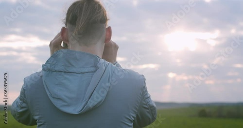 Back view of unrecognizable man observing landscape in binoculars copy text space. Detailed macro portrait of traveler looking afar in field-glass slow motion. Travel exploration trekking equipment
