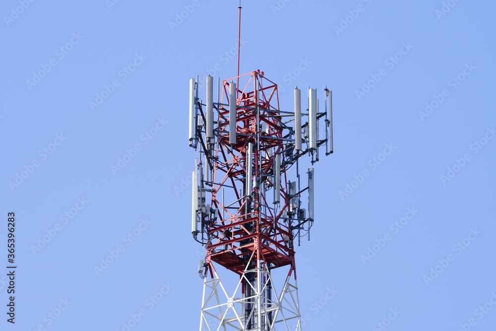 Small Cell 3G, 4G, 5G System. Macro Base Station or Base Transceiver Station. Wireless Communication Antenna Transmitter tower against blue sky background. Small Cell 3G, 4G, 5G System. Macro Base Station or Base Transceiver Station. Wireless Communication Antenna Transmitter tower against blue sky background.