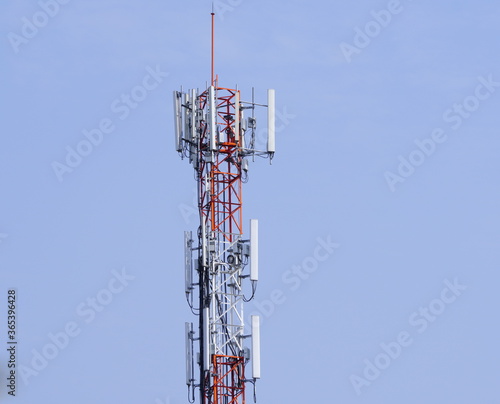 Small Cell 3G, 4G, 5G System. Macro Base Station or Base Transceiver Station. Wireless Communication Antenna Transmitter tower against blue sky background.