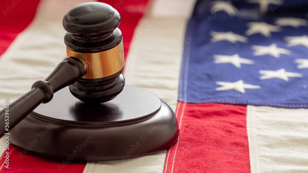 Justice in USA. Law gavel on United States of America flag.