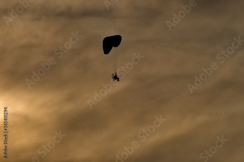 paraglider in the sky at sunset