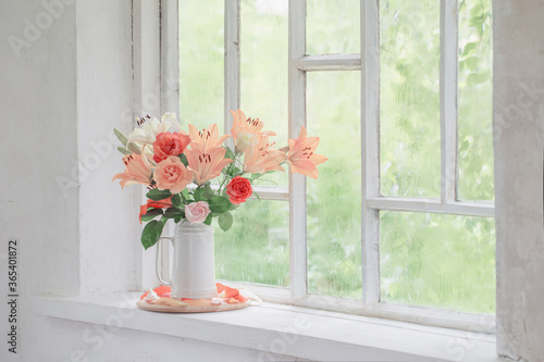 summer flowers in vase on background window with drops water