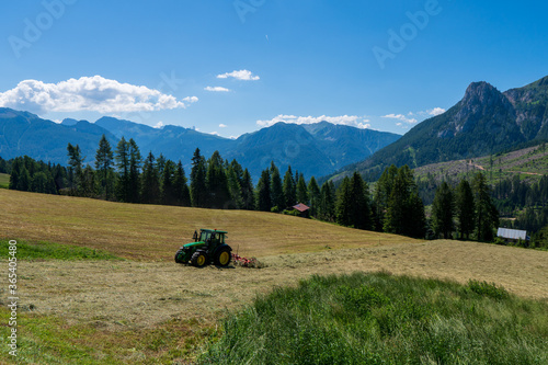 Tractor Turning Hay in the field