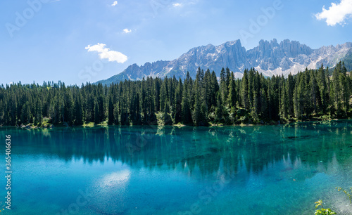 Lake Carezza or Karersee at sunset  wide angle view of scenic landscape in Italy. Dolomites mountains on background  Italian Alps. Nature and travel concepts