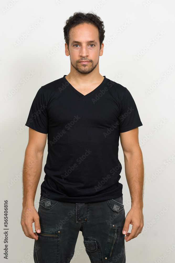 Fototapeta premium Portrait of handsome bearded Hispanic man with curly hair