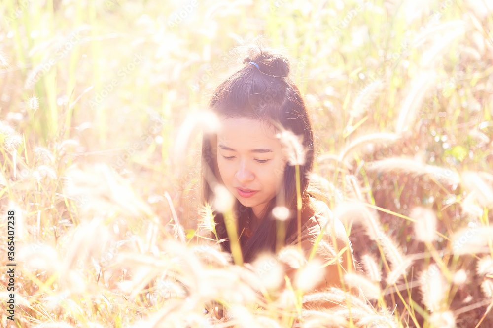 Romantic girl standing on the mountain in the flowers grass field at Thong Pha Phoom national park ,Kanchanaburi province ,Thailand. Romantic girl standing on the mountain in the flowers grass field at Thong Pha Phoom national park ,Kanchanaburi province ,Thailand.