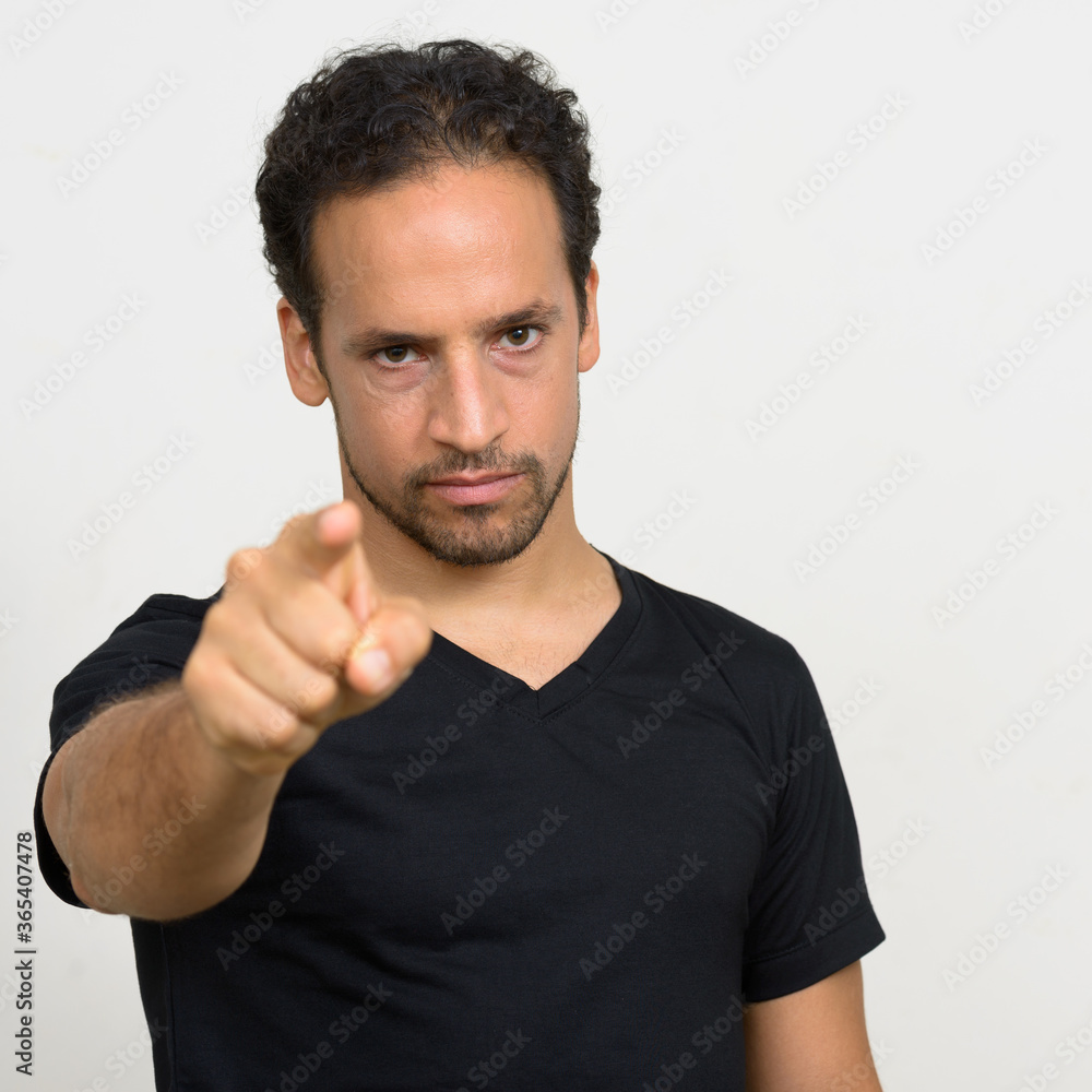 Portrait of handsome bearded Hispanic man with curly hair Portrait of handsome bearded Hispanic man with curly hair