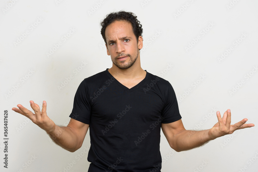 Portrait of handsome bearded Hispanic man with curly hair Portrait of handsome bearded Hispanic man with curly hair