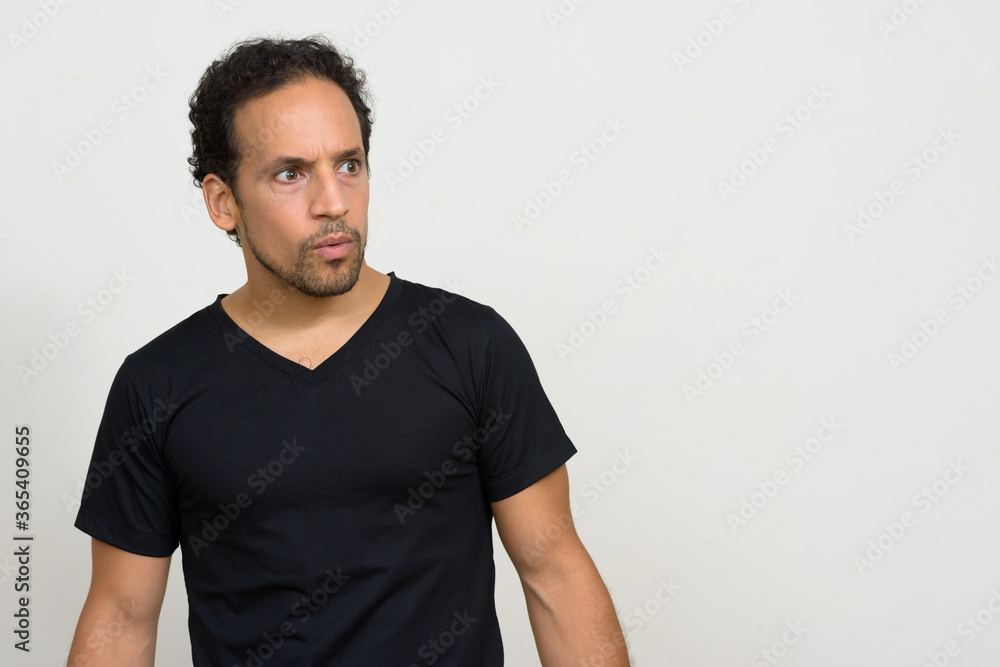 Portrait of handsome bearded Hispanic man with curly hair Portrait of handsome bearded Hispanic man with curly hair