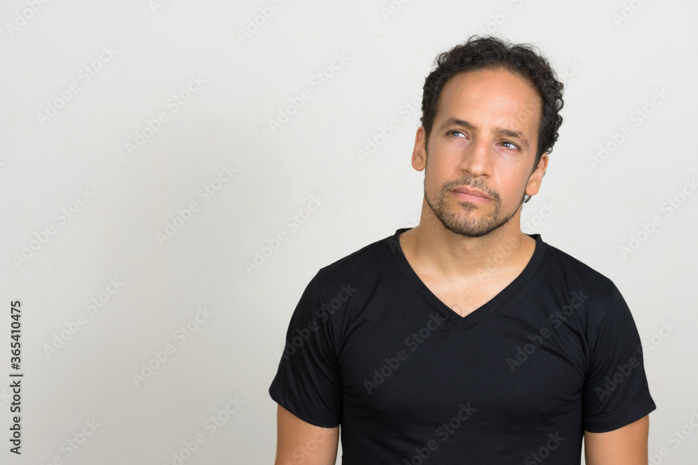 Portrait of handsome bearded Hispanic man with curly hair Portrait of handsome bearded Hispanic man with curly hair