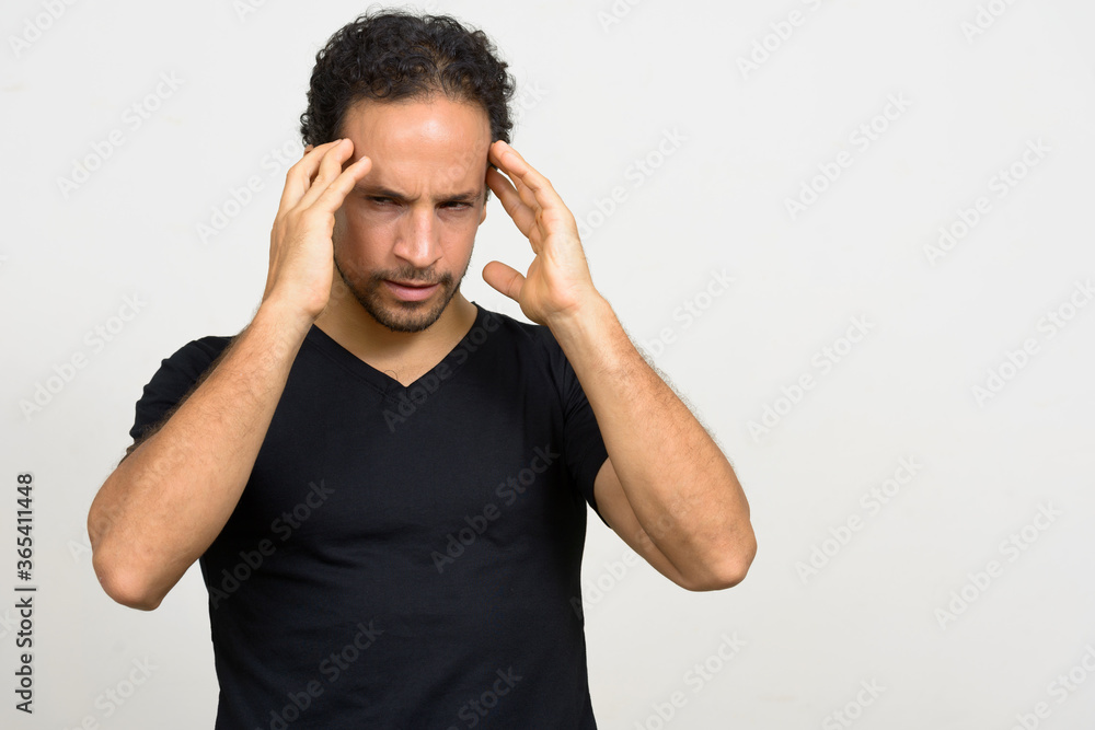 Portrait of handsome bearded Hispanic man with curly hair Portrait of handsome bearded Hispanic man with curly hair