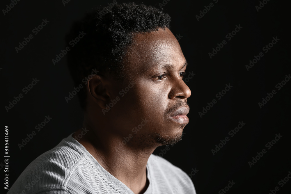 Sad African-American man on dark background. Stop racism Sad African-American man on dark background. Stop racism