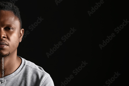 Sad African-American man on dark background. Stop racism photo